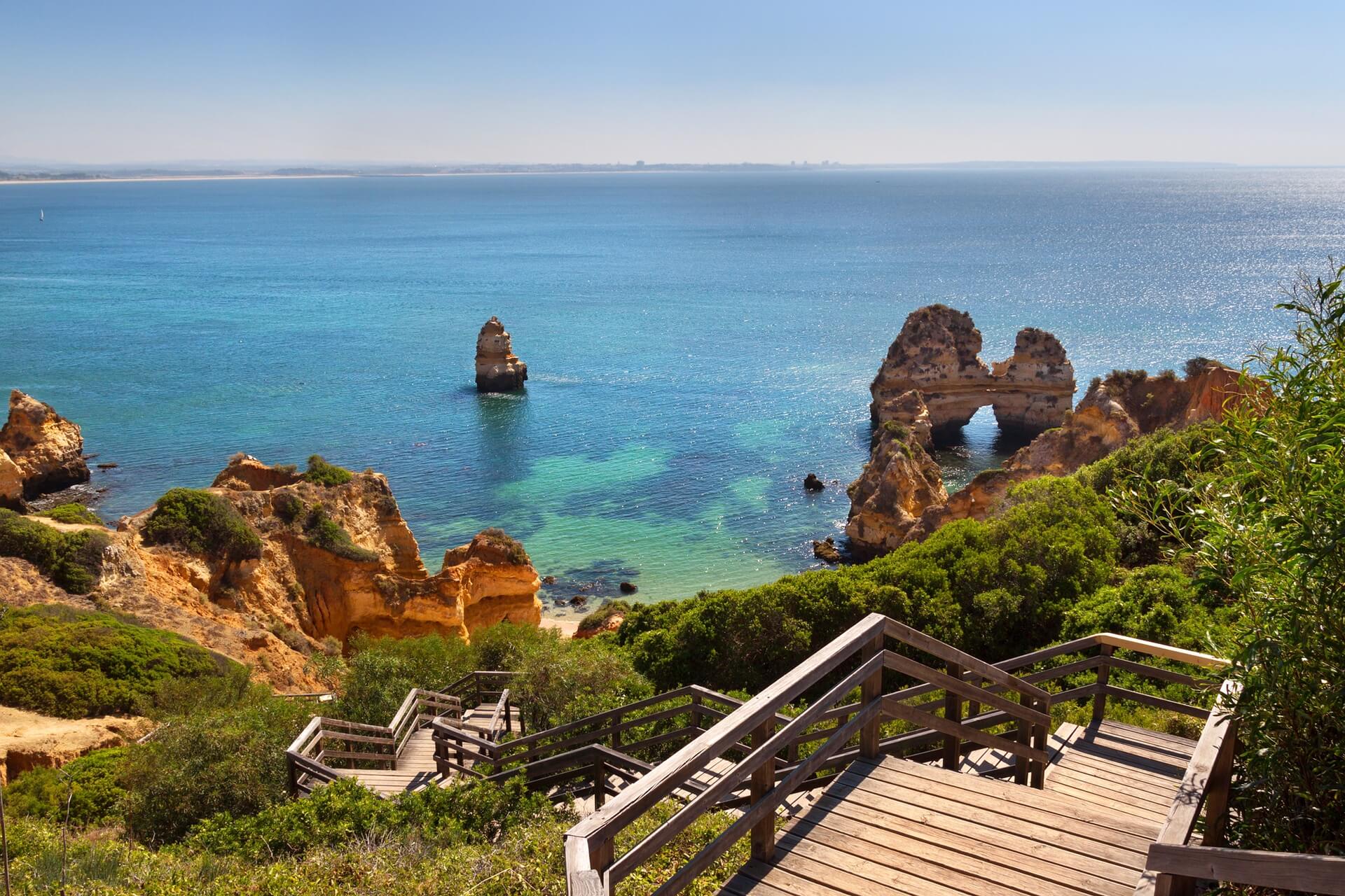 wooden footbridge beautiful beach with cliffs algarve portugal